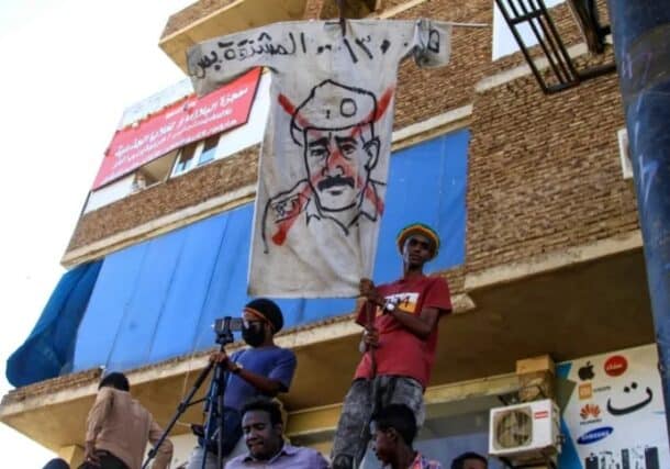 Anti-coup protesters in Khartoum holds a banner al-Burhan to the gallows on November 17, 2022