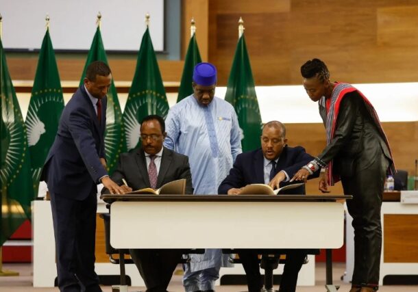 Redwan Hussein (L), for the Ethiopian government, and Getachew Reda (R), TPLF representative, sign a peace agreement between in Pretoria, South Africa on Nov 2, 2022 AFP .