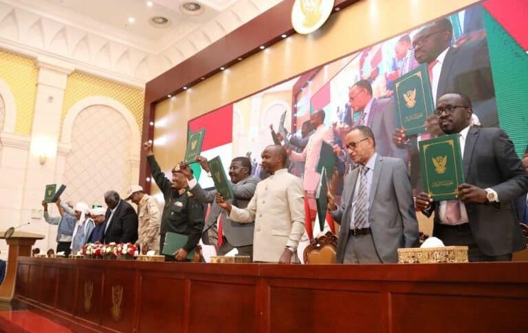Sudan's political and military leaders hold up the signed framework agreement on December 5, 2022
