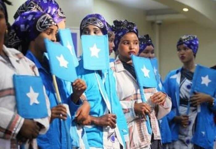 Women hold Somali flags at a Women's Peace Forum in Mogadishu, November 2018 UNDP photo