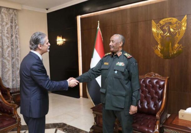 Al-Burhan shakes hands with Egyptian ambassador to Sudan on January 10, 2023