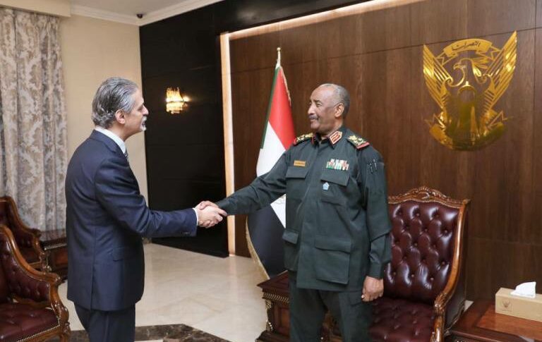 Al-Burhan shakes hands with Egyptian ambassador to Sudan on January 10, 2023