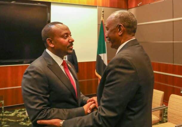 General al-Burhan shakes hands with Ethiopian Prime Minister Abiy Ahmed in Doha on March 5, 2023