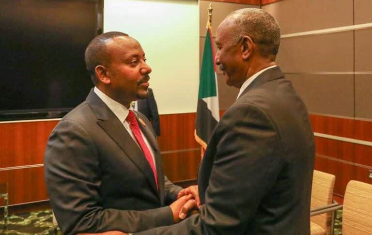 General al-Burhan shakes hands with Ethiopian Prime Minister Abiy Ahmed in Doha on March 5, 2023