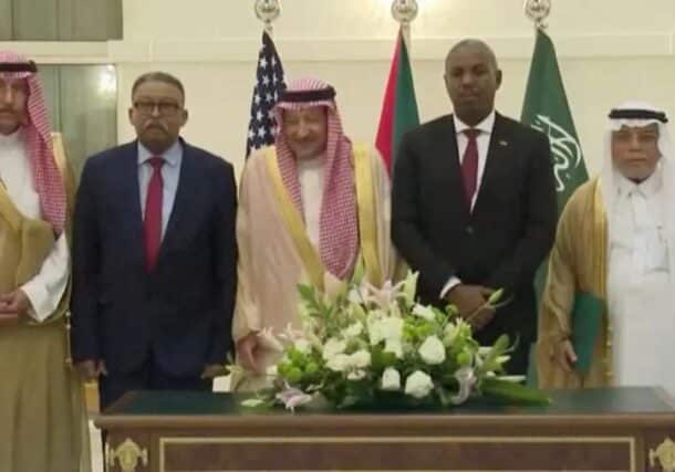 The heads of the Sudanese army and RSF delegations pose with Saudi officials in Jeddah on May 11, 2023