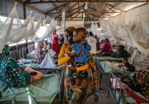 A mother holds her child in a ward for malaria patients at the Paediatrics hospital, in El Fasher, North Darfur, Sudan (MSF photo)
