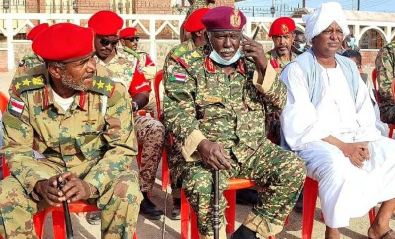 Shهbah Dirar talks on the phone while dressed in military attire (File photo)
