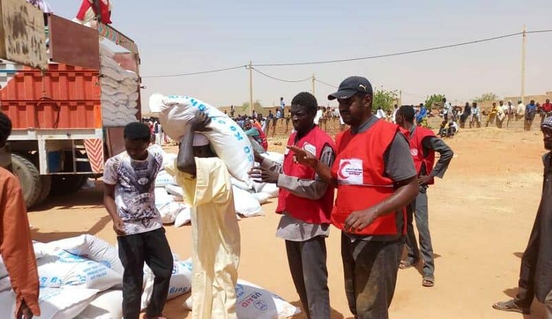 Sudanese Red Crescent Society volunteers distribute food to people in Khartoum who have been affected by the ongoing conflict in the country in late May 2023. (SRCS)