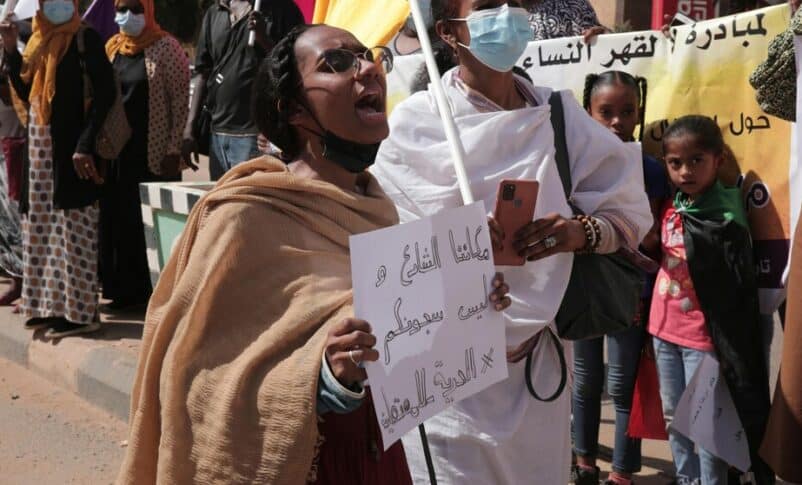 Women chant slogans protesting violence against women before the U.N. rights office in Khartoum, Sudan, Feb. 2, 2022. (AP photo)
