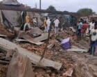 Civilians in Nyala gather near a house destroyed by the RSF shells on October 14, 2023