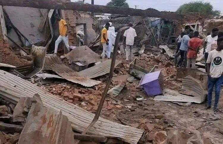 Civilians in Nyala gather near a house destroyed by the RSF shells on October 14, 2023