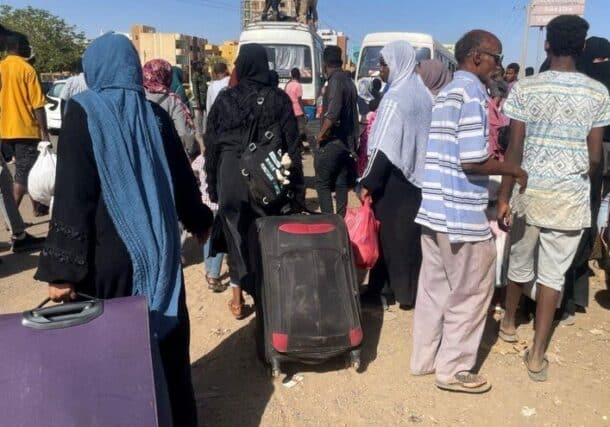 People gather at a bus stop to flee from Khartoum during clashes between the paramilitary Rapid Support Forces and the army, in Khartoum, Sudan, April 19, 2023. (Reuters)