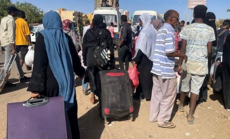 People gather at a bus stop to flee from Khartoum during clashes between the paramilitary Rapid Support Forces and the army, in Khartoum, Sudan, April 19, 2023. (Reuters)