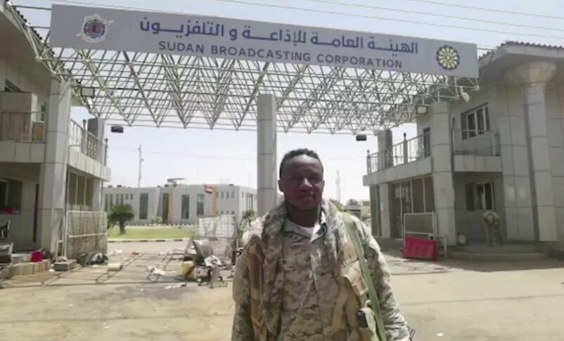 RSF member stands in front of Sudan Broadcasting Corporation in Omdurman