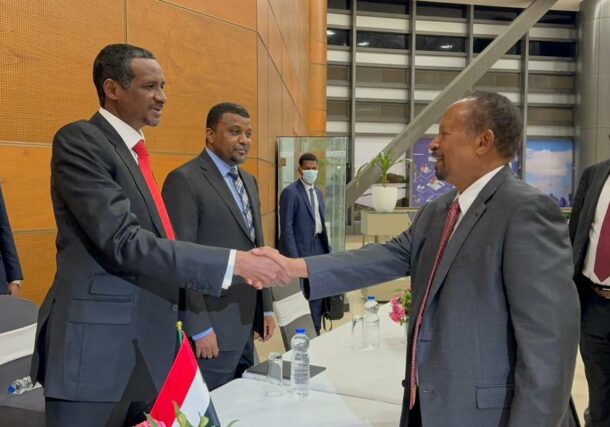 Former PM Abdallah Hamdok shakes and with RSF leader Mohamed Hamdan Daglo before a joint meeting in Addis Ababa on December 1, 2023