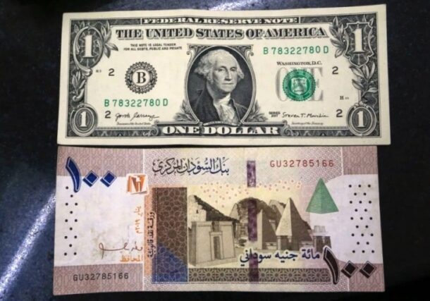 A picture taken on January 21, 2020, shows a US 1 dollar bill and a Sudanese 100 pound bill at a brokerage in the capital Khartoum on January 21, 2020. (AFP)