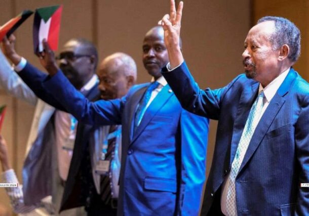 Hamdok and some of Tagadum leaders raise their hands at the opening session of their three-day meeting on May 27, 2024