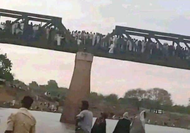 Civilians cross Al-Dinder Bridge heading to Gederaf after the REF control of the town on July 5, 2024