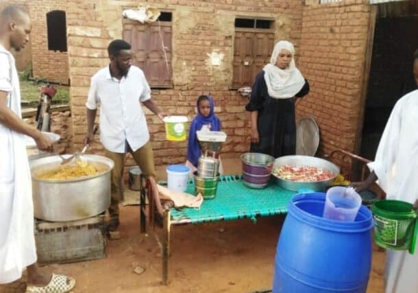 Volunteers prepare a meal for the residents of a South belt neighbourhood