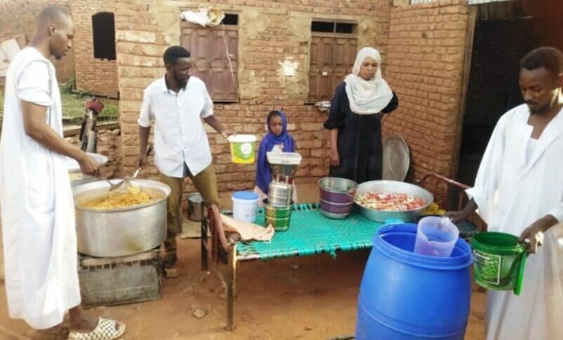 Volunteers prepare a meal for the residents of a South belt neighbourhood
