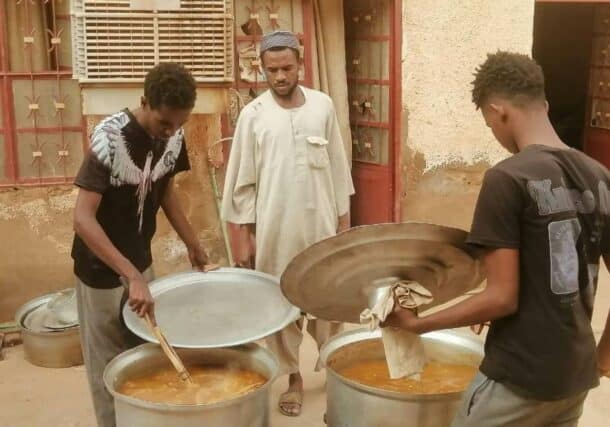 Young men participate in the collective kitchen in Omdurman July 24, 2024