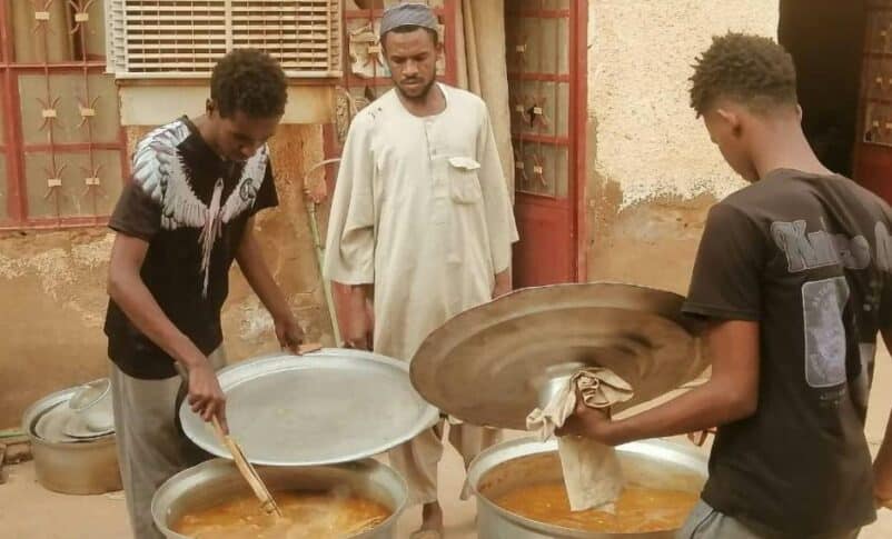 Young men participate in the collective kitchen in Omdurman July 24, 2024