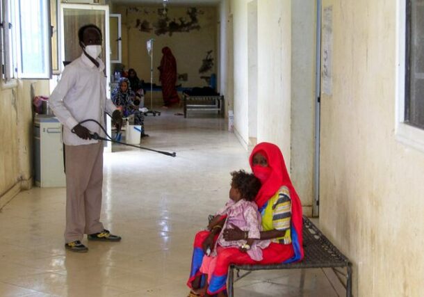 A man disinfects a rural isolation centre where patients are being treated for cholera in Kassala state, eastern Sudan. AFP