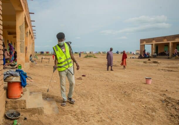 A volunteer sprays the compound and spaces at Alashpal gathering point for displaced persons in West Kassala locality on September 3, 2024 (UNICEF photo)