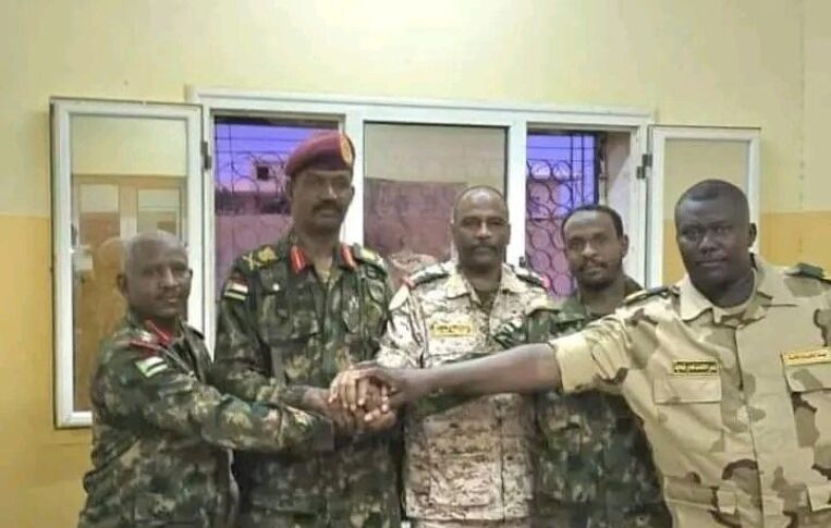 Abu Aqla Kikl (2nd from left) in Sudanese army uniform after his defection from the RSF.