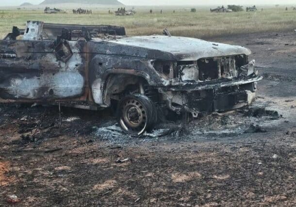 An RSF destroyed vehicle, while the elements of Joint Force inspect other vehicles they seized after the fighting on October 1, 2024