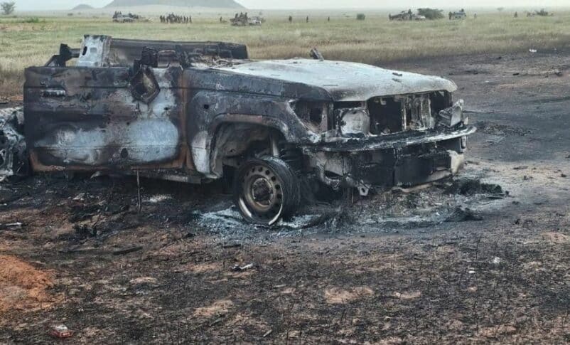 An RSF destroyed vehicle, while the elements of Joint Force inspect other vehicles they seized after the fighting on October 1, 2024