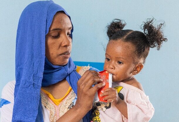 Eleven-month-old Yadin nibbles on ready-to-use therapeutic food (RUTF) in Sudan. (UNICEF photo)