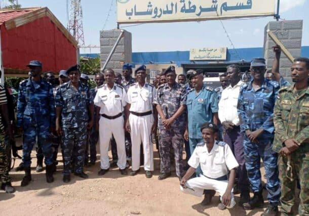 Sudanese policemen pose outside the police station in Al-Droushab, Khartoum Bahri