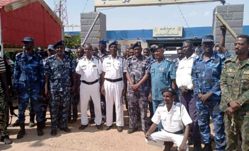 Sudanese policemen pose outside the police station in Al-Droushab, Khartoum Bahri