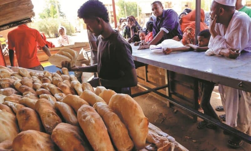 People gather to get bread while clashes rage between the Sudanese army and the paramilitary RSF in Khartoum North, on April 24, 2023. Reuters photo