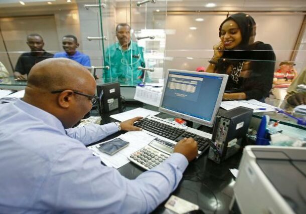 Customers making cash transactions at teller's windows at Bank of Khartoum. (file GettyImages)