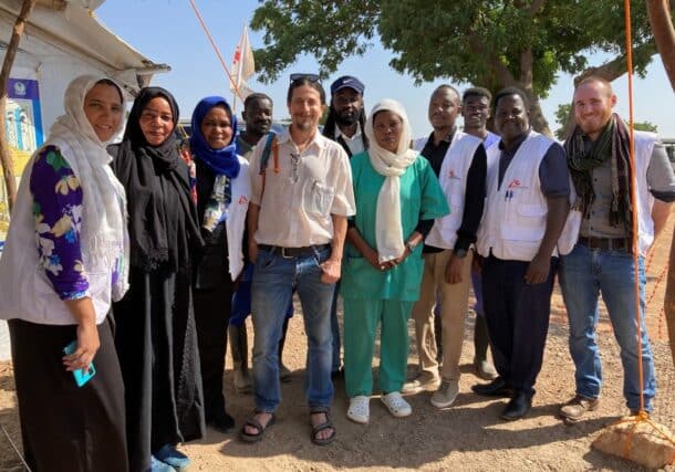 MSF head Stephen Cornish poses with the Sudanese medical workers at at Um Rakuba camp in Gederaf on December 30, 2024