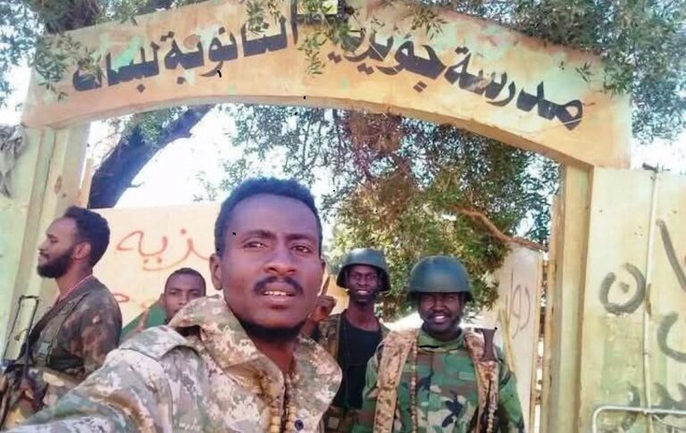 Sudanese army soldiers stand outside the Juwayriyah School south of Shambat, Bahri, on Jan 21, 2025