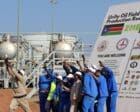 Workers take a photo during a ceremony marking the restarting of crude oil pumping at the Unity oil fields in South Sudan, Jan. 21, 2019 - Reuters file photo