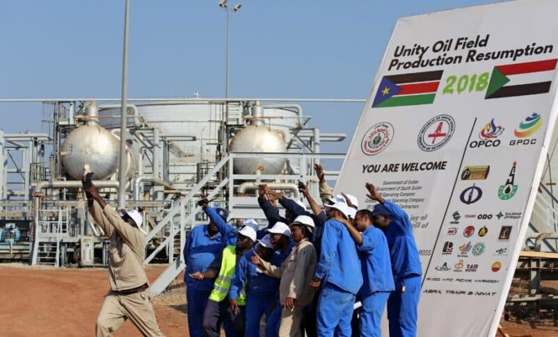 Workers take a photo during a ceremony marking the restarting of crude oil pumping at the Unity oil fields in South Sudan, Jan. 21, 2019 - Reuters file photo