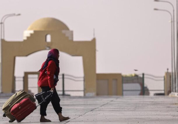 A woman fleeing war-torn Sudan crosses into Egypt through the Argeen Land Port on May 12., 2023 AFP photo-1
