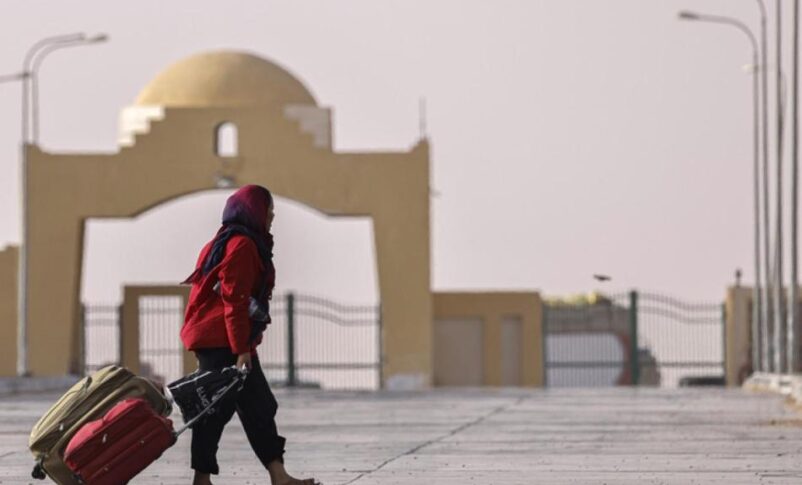 A woman fleeing war-torn Sudan crosses into Egypt through the Argeen Land Port on May 12., 2023 AFP photo-1