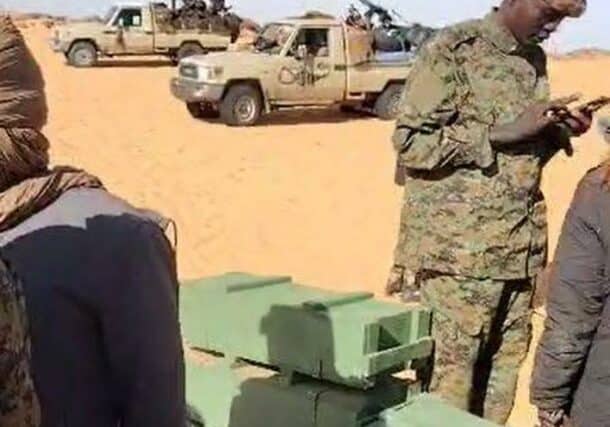 Joint Force troops stand near by captured ammunition boxes coming from outside Sudan for the RSF on November 1, 2024