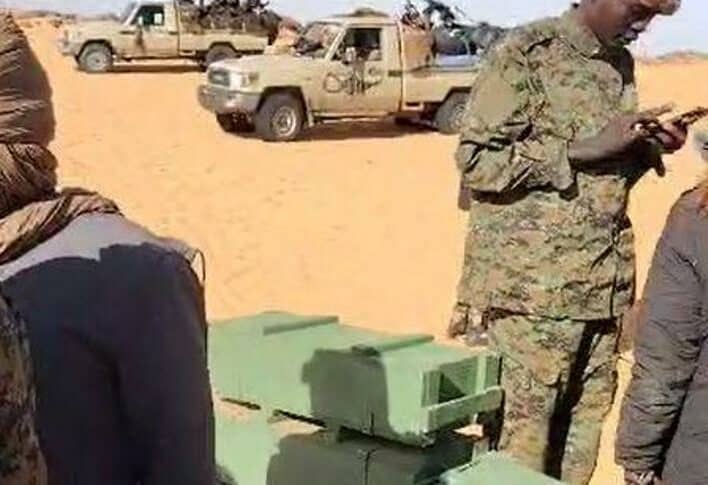 Joint Force troops stand near by captured ammunition boxes coming from outside Sudan for the RSF on November 1, 2024