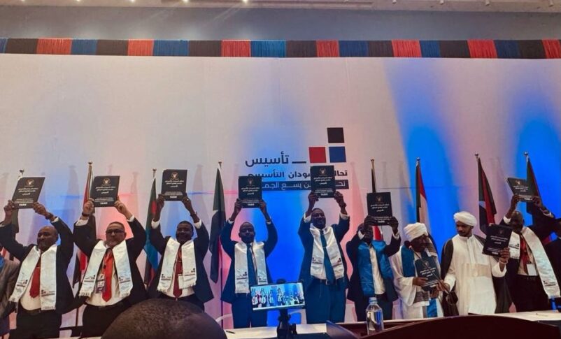 Signatories display the signed political charter for Sudan's transition at a ceremony in Nairobi, February 22, 2025.
