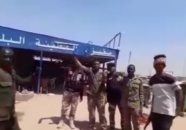 Sudanese soldiers stand outside a bakery in Al-Qutayna on February 23, 2025.