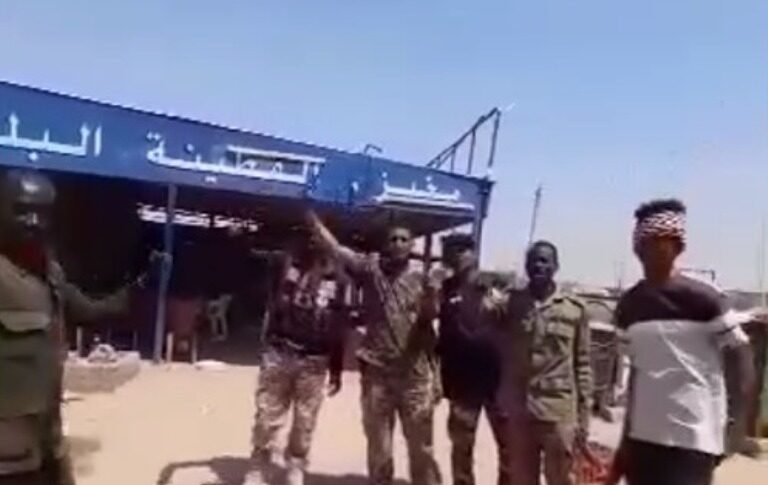 Sudanese soldiers stand outside a bakery in Al-Qutayna on February 23, 2025.