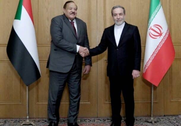 Sudan's FM Ali Youssif, shakes hands with Iranian counterpart Seyed Abbas Araghchi, in Tehran on Feb 18, 2025