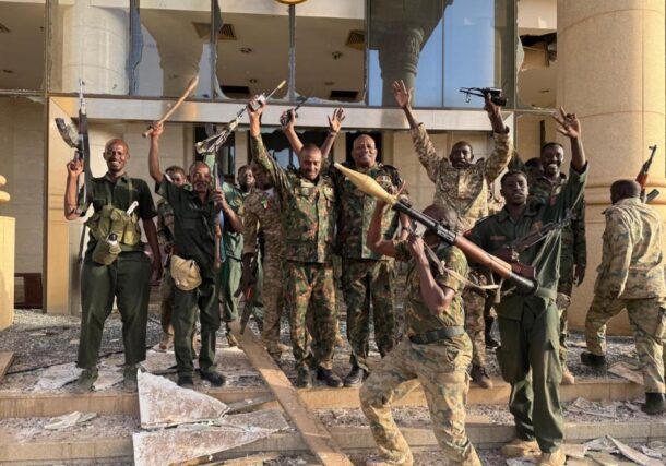 Sudanese army officers and soldiers stand at the entrance of the Republican Palace in Khartoum on March 21, 2025