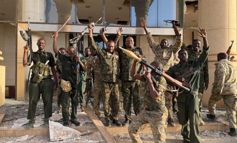 Sudanese army officers and soldiers stand at the entrance of the Republican Palace in Khartoum on March 21, 2025